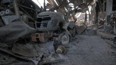Burnt goods and equipment inside the warehouse. Destroyed logistics hub as a result of a rocket attack by Russian troops near Kyiv. War between Russia and Ukraine.