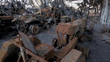 Burnt goods and equipment inside the warehouse. Destroyed logistics hub as a result of a rocket attack by Russian troops near Kyiv. War between Russia and Ukraine.