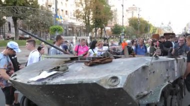 KYIV, UKRAINE - AUG 22, 2022: Destroyed Russian military equipment in the center of Kyiv on Khreshchatyk. People inspect and photograph captured Russian tanks on Ukraines Independence Day.