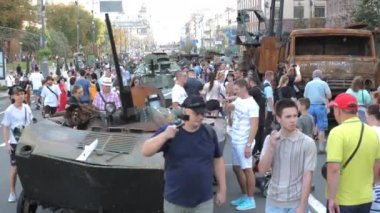 KYIV, UKRAINE - AUG 22, 2022: Destroyed Russian military equipment in the center of Kyiv on Khreshchatyk. People inspect and photograph captured Russian tanks on Ukraines Independence Day.