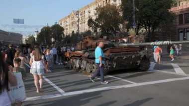 KYIV, UKRAINE - AUG 22, 2022: Destroyed Russian military equipment in the center of Kyiv on Khreshchatyk. People walk and take pictures of captured Russian tanks on the day of independence of Ukraine.