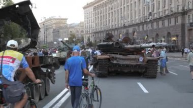 KYIV, UKRAINE - AUG 22, 2022: Destroyed Russian military equipment in the center of Kyiv on Khreshchatyk. People inspect and photograph captured Russian tanks on Ukraines Independence Day.