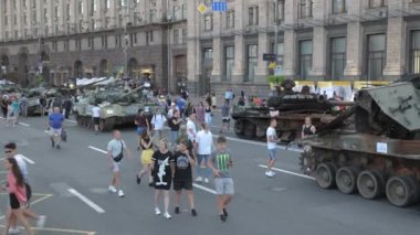 KYIV, UKRAINE - AUG 22, 2022: Destroyed Russian military equipment in the center of Kyiv on Khreshchatyk. People inspect and photograph captured Russian tanks on Ukraines Independence Day.