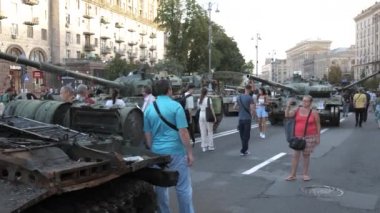 KYIV, UKRAINE - AUG 22, 2022: Destroyed Russian military equipment in the center of Kyiv on Khreshchatyk. People inspect and photograph captured Russian tanks on Ukraines Independence Day.