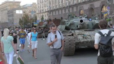 KYIV, UKRAINE - AUG 22, 2022: Destroyed Russian military equipment in the center of Kyiv on Khreshchatyk. People inspect and photograph captured Russian tanks on Ukraines Independence Day.
