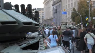 KYIV, UKRAINE - AUG 22, 2022: Destroyed Russian military equipment in the center of Kyiv on Khreshchatyk. People inspect and photograph captured Russian tanks on Ukraines Independence Day.