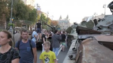 KYIV, UKRAINE - AUG 22, 2022: Destroyed Russian military equipment in the center of Kyiv on Khreshchatyk. People inspect and photograph captured Russian tanks on Ukraines Independence Day.