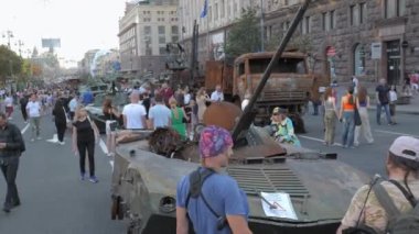 KYIV, UKRAINE - AUG 22, 2022: Destroyed Russian military equipment in the center of Kyiv on Khreshchatyk. People inspect and photograph captured Russian tanks on Ukraines Independence Day.