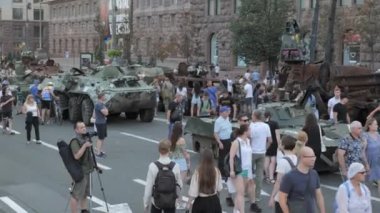 KYIV, UKRAINE - AUG 22, 2022: Destroyed Russian military equipment in the center of Kyiv on Khreshchatyk. People inspect and photograph captured Russian tanks on Ukraines Independence Day.