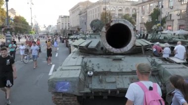 KYIV, UKRAINE - AUG 22, 2022: Destroyed Russian military equipment in the center of Kyiv on Khreshchatyk. People inspect and photograph captured Russian tanks on Ukraines Independence Day.