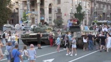 KYIV, UKRAINE - AUG 22, 2022: Destroyed Russian military equipment in the center of Kyiv on Khreshchatyk. People inspect and photograph captured Russian tanks on Ukraines Independence Day.