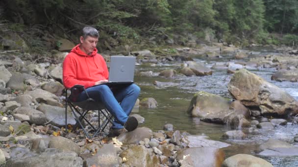 Man Works Laptop Stream Nature Concept Freelancing Digital Nomad Remote — Vídeos de Stock