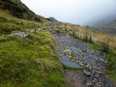 Cader Idris mountain with lake near the town of Dolgellau, in National Park Snowdonia in Wales, misty morning 2022.