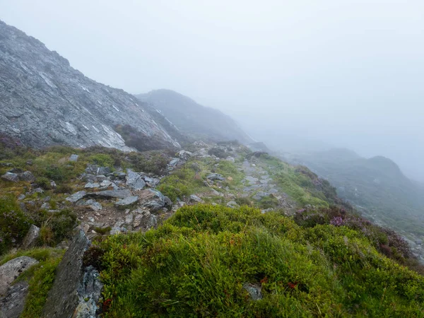 Cader Idris mountain with lake near the town of Dolgellau, in National Park Snowdonia in Wales, misty morning 2022.