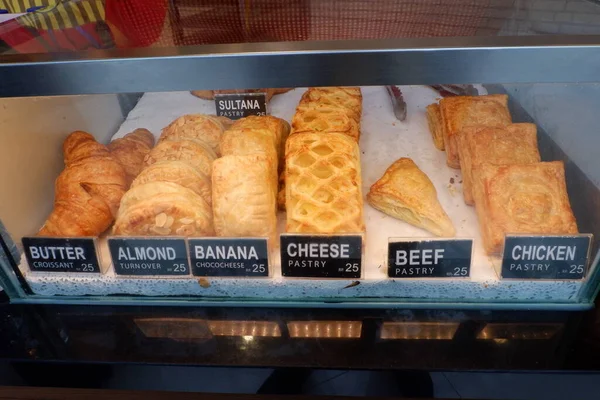 fresh croissants in bakery store