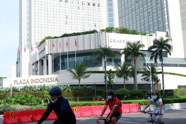 young woman in a suit and a white shirt and a blue dress on the street