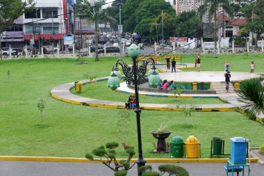 Medan, Indonesia - November 16, 2021: Park view at the center of a city with a park lamp, and people doing activity, and a jogging track