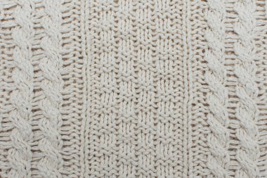 Örgü arka plan, doku, desen. Örgü örgüsüyle numunenin yakın çekimi.