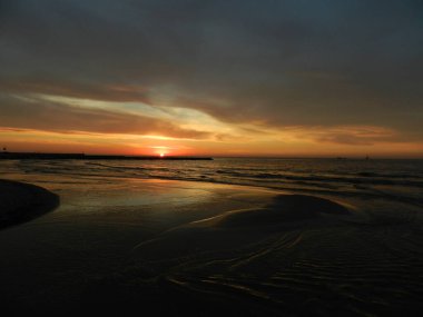 Beautiful sunset on the Baltic Sea. A walk along the seashore during your vacation. Perfect wallpaper.
