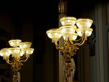 A decorative lamp brightens up a dark room. Light triumphs over darkness.