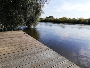 Photo of a river flowing through a beautiful park. Spring Summer. Perfect for wallpaper.