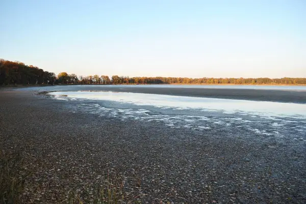 An atmospheric sunset over a beautiful lake in the park. 