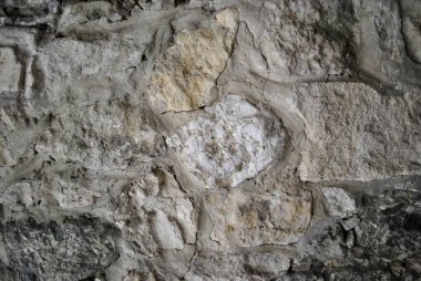 Stones and rocks. An old crumbling wall with a beautiful, rough structure. 