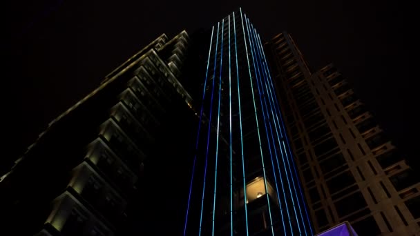 Illumination of modern skyscrapers illuminated urban architecture at night, cityscape — Stock Video