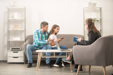 Yaşam koçu. Telefon bağımlılığı. Baba ve çocuk psikolog seansında. Aile terapisi