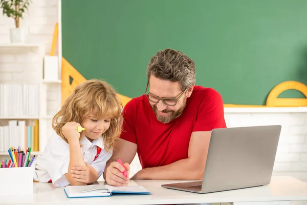 Teacher and pupil study in classroom with laptop, education — Stock Photo, Image
