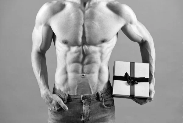 Sexy muž s svalnatým trupem oříznutý pohled držet dárek box. Fitness dárek. Dárek k narozeninám — Stock fotografie