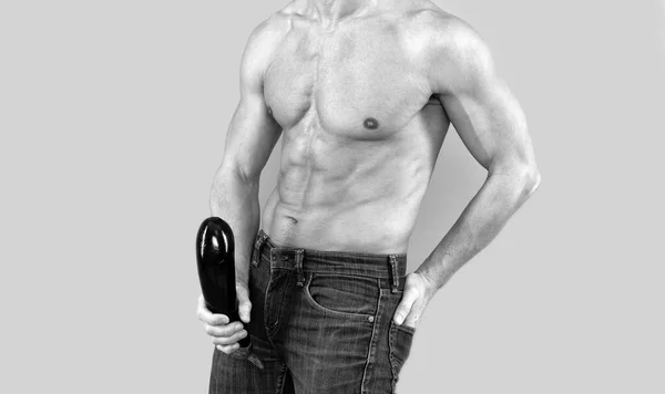 Muscular man cropped view hold firm and large eggplant at crotch level, penis enlargement. — 图库照片