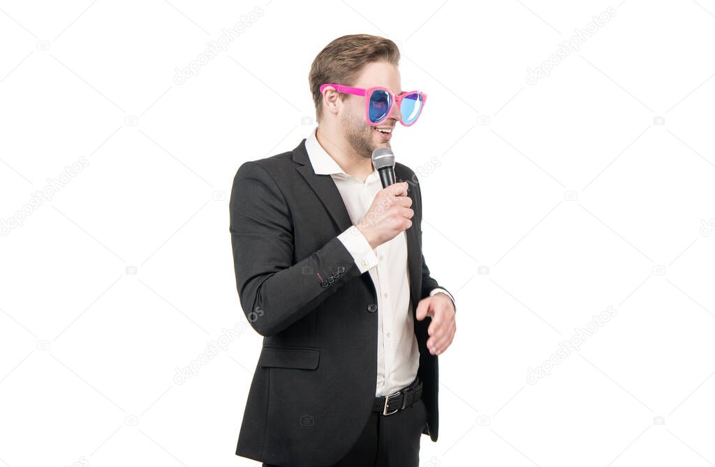 Professional man showman in funny glasses speak to microphone isolated on white, speaker