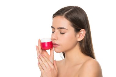 Genç kadın cilt için krem kavanozu tutuyor. Beyaz arka planda, fotokopi alanı ile izole edilmiş.