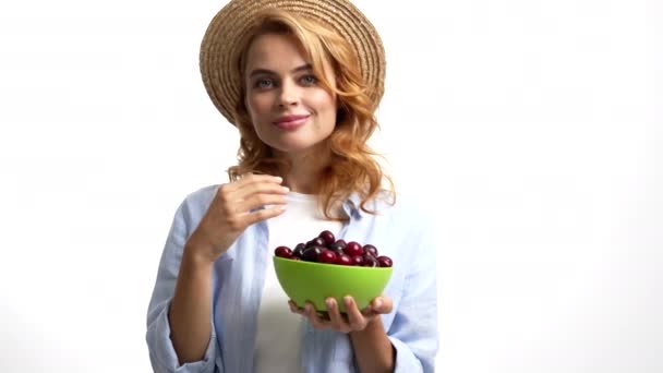 Sexy pretty lady in straw summer hat eating sweet cherry berry sensually, seasonal fruit — Video Stock