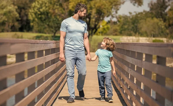 Happy single dad leading small son outside, adoption — Stock Photo, Image