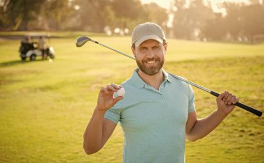 happy male golf player on professional course with green grass hold ball, golf