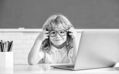 september 1. e-learning. child studying on computer. happy teen boy in classroom.