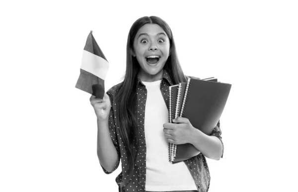 Asombrado niño sostiene bandera francesa y escuela copybook para estudiar aislado en blanco, estudiar en el extranjero — Foto de Stock