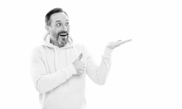 Man with beard and moustache in hoody presenting product on copy space isolated on white, thumb up. — стоковое фото