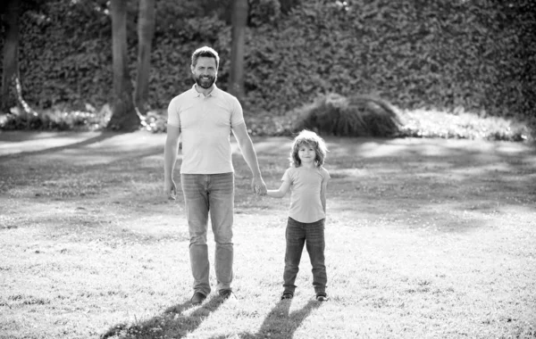 Pai e filho andando no parque. valor familiar feliz. infância e paternidade. — Fotografia de Stock
