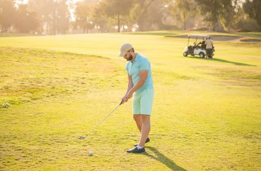 young man playing golf game on green grass, sports