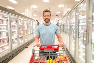 customer with shopping cart buying food at grocery, supermarket