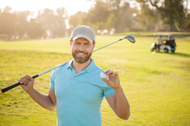 happy male golf player on professional course with green grass hold ball, golf