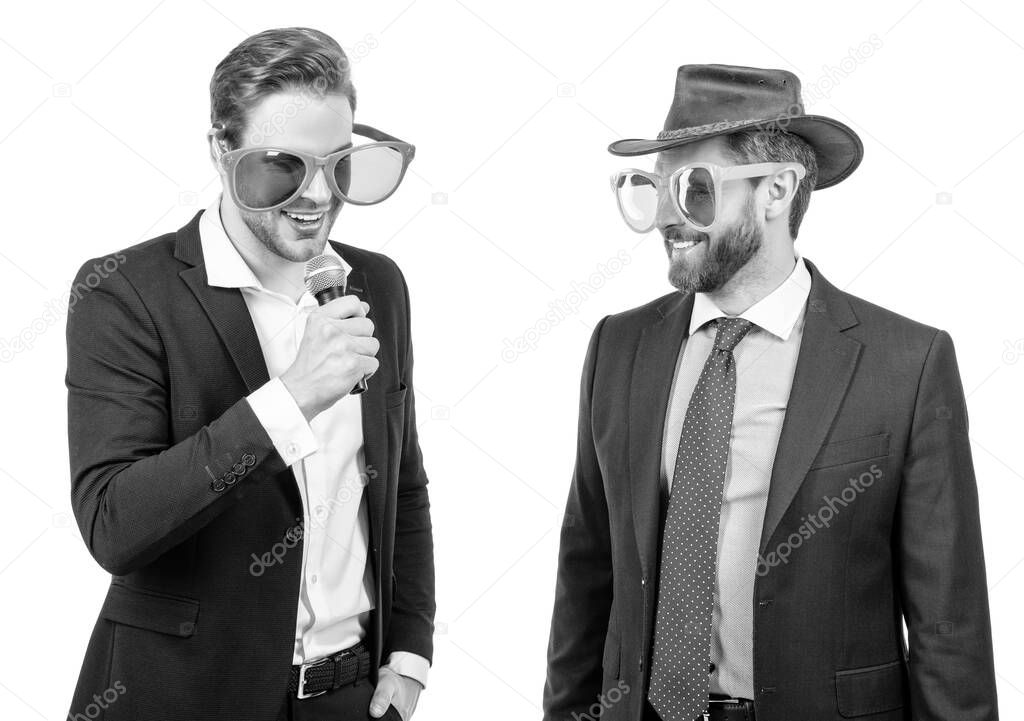 Showman in funny glasses announce businessmen to microphone on corporate party, announcement