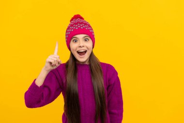 inspired wit idea child in knitted hat. kid wear warm clothes on yellow background.