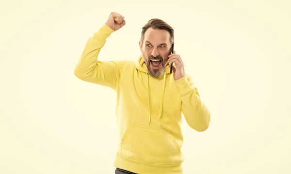 Happy mature man with beard and moustache in hoody speaking on phone isolated on white, phone call. — Photo