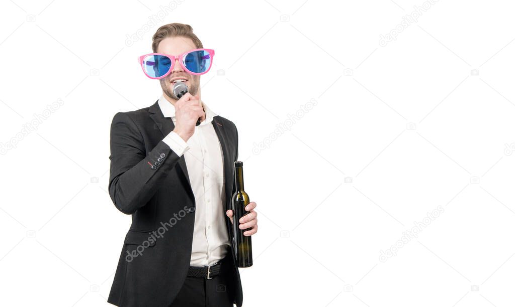 Wine and song. Funny man sing to microphone. Karaoke party. Business party. Corporate event