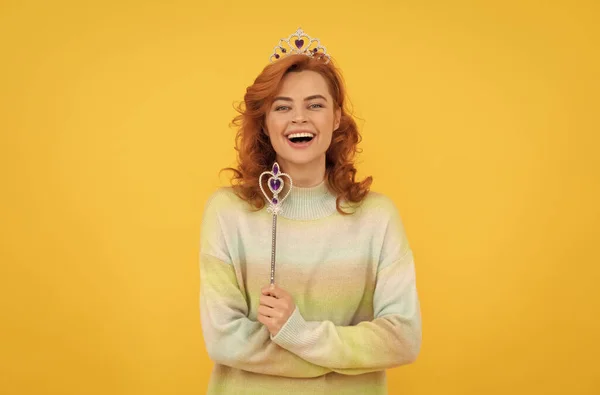 true emotions. happy redhead woman in crown. queen hold magic wand. arrogant princess in tiara