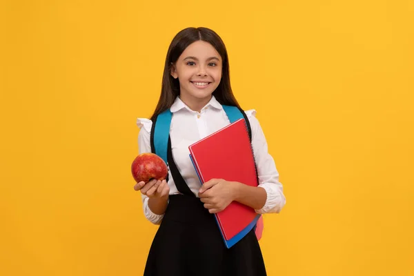 September 1. Happy girl hold apple and books. School education. September 1. Back to school — Stock Photo, Image